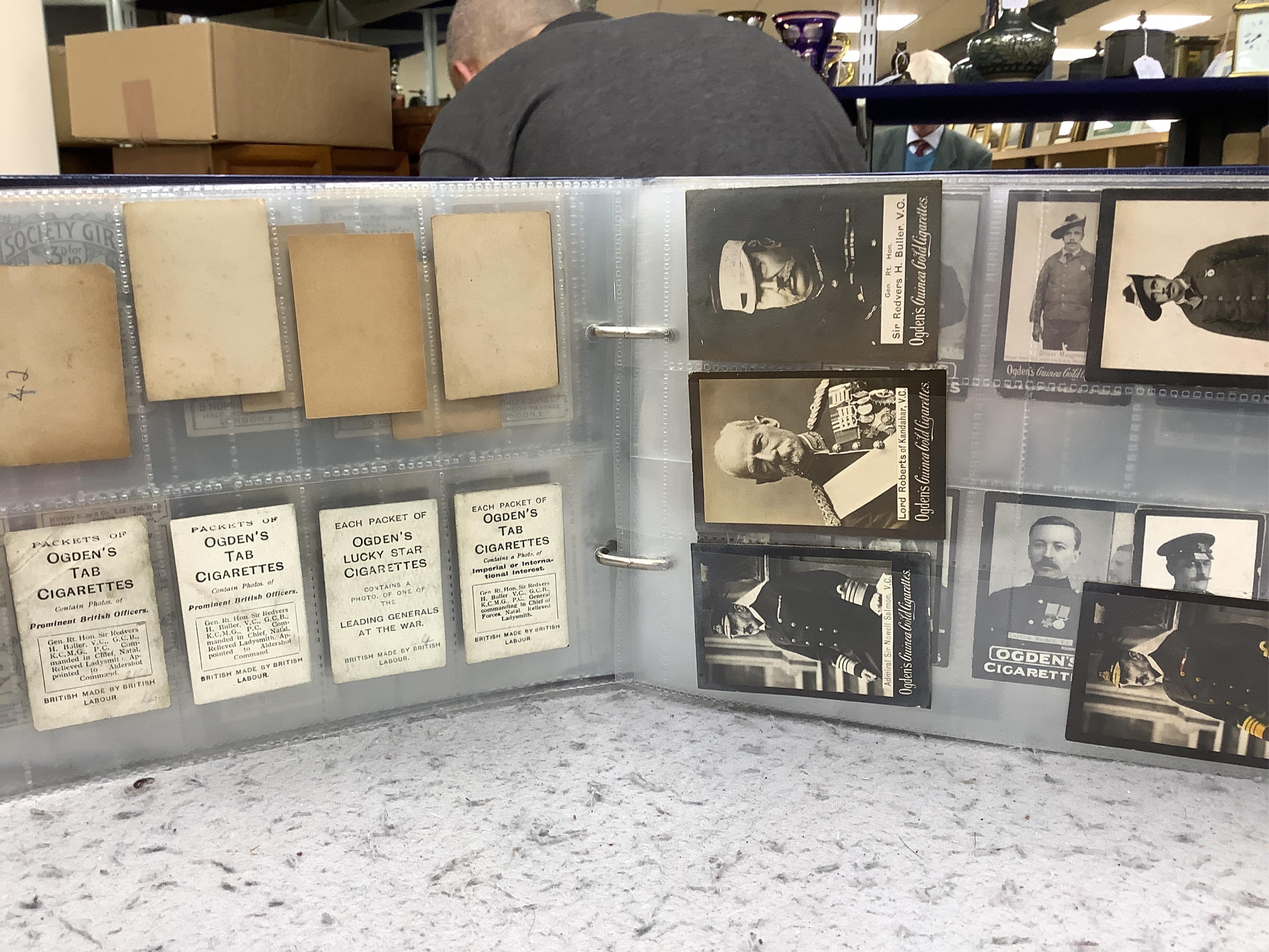 Four albums of assorted cigarette cards; military badges, heroes, soldiers and war, and some loose silks.